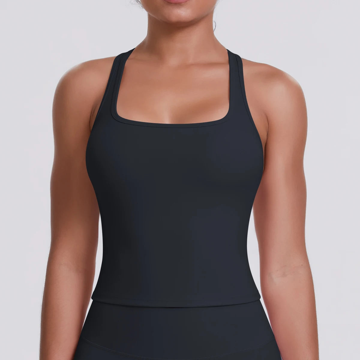 Asset Type: Product Detail Image
Product: Fierce Ember Define™ Square Neck Tank
Brand: Mind Body and Soles Activewear
Collection: Fierce Ember™
Colour: Midnight Black
Category: Women's premium square neck activewear tank
This close-up product detail image showcases the Fierce Ember Define™ Square Neck Tank in Midnight Black, focusing on the upper-body fit and premium construction. The image highlights the elegant square neckline, supportive shoulder straps and sculpting silhouette, allowing customers and A