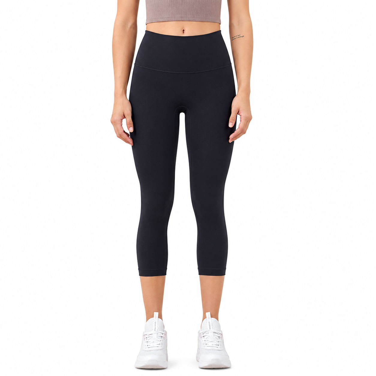 Front view of a model wearing Freedom Flow™ Studio Capri Leggings in midnight black. High-waisted women's yoga leggings with a sculpting, supportive fit by Mind Body & Soles.