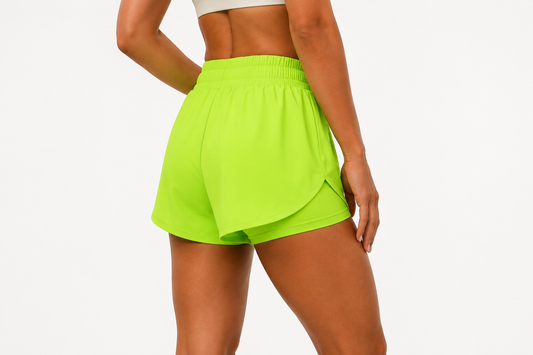 Rear view of a model wearing Power Vibe™ Sprint 2-in-1 Running Shorts in Electric Lime, highlighting the supportive 2-in-1 design, high-rise waistband and lightweight performance fit.