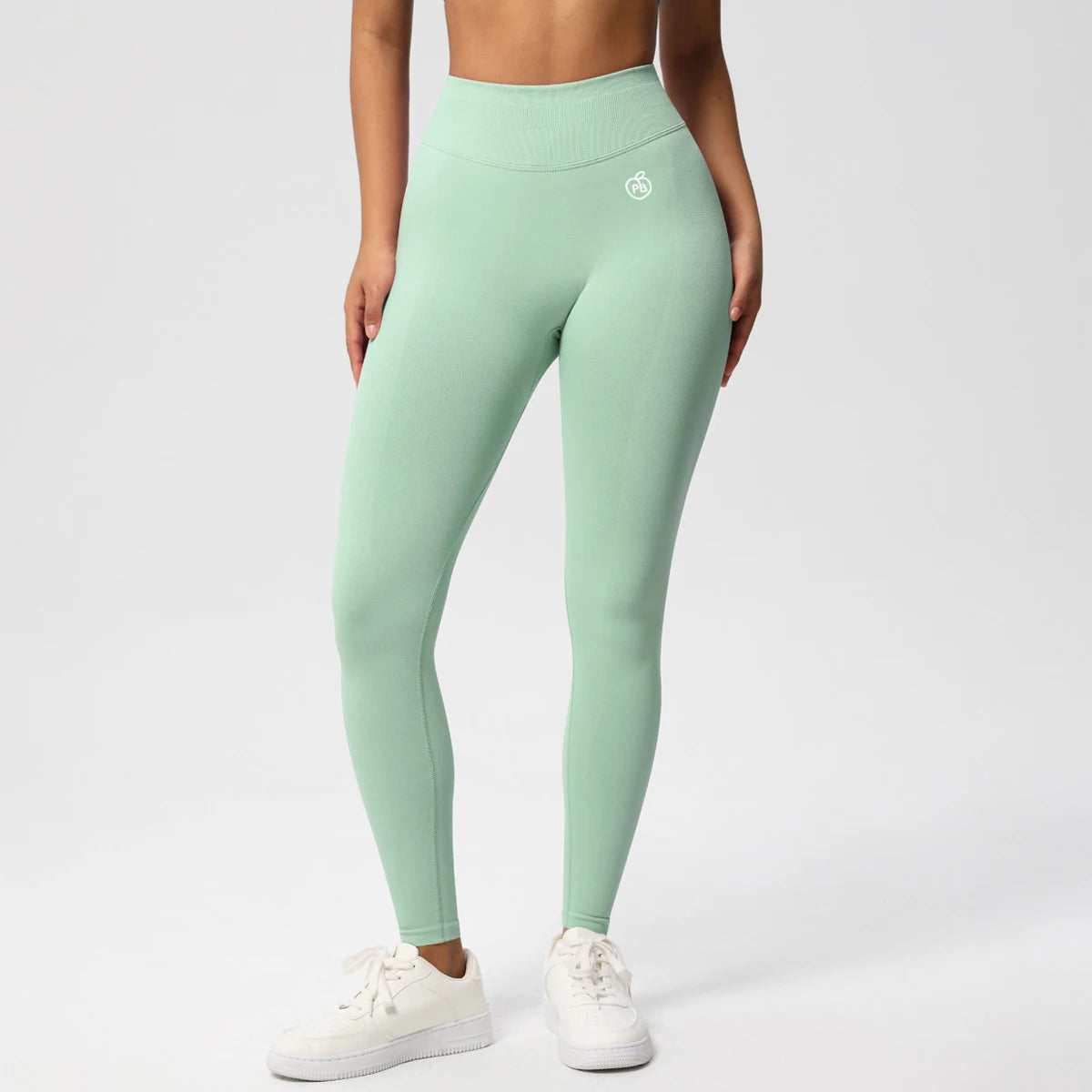 Fierce Ember Ultimate mint green high-rise seamless leggings with full-length fit and white hip logo, shown on a white studio background.