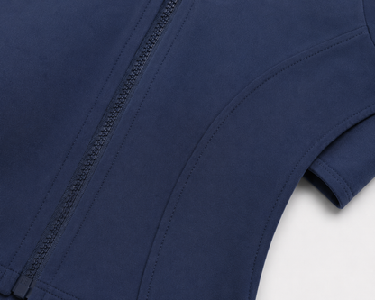 Fierce Ember™ Elevate women’s gym jacket in Steel Blue close-up showing premium fabric, full zip and sculpting seam detail.