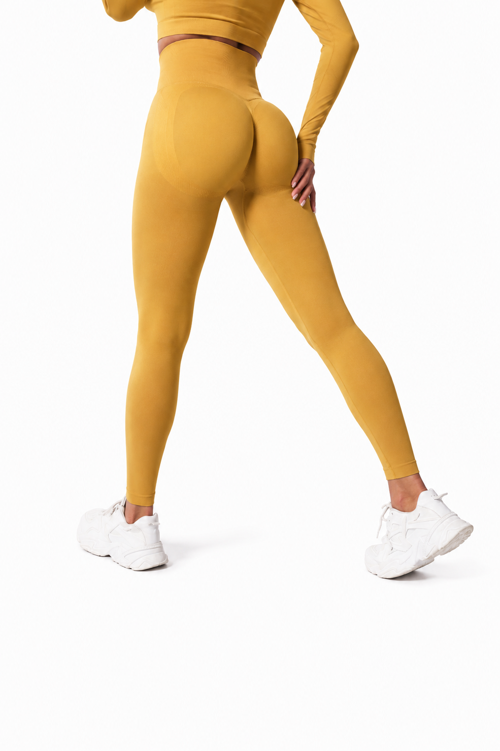 Close-up rear view of Fierce Ember Signature Leggings in sunrise yellow, showcasing the seamless sculpting design, high-waisted fit and contour-enhancing performance fabric.