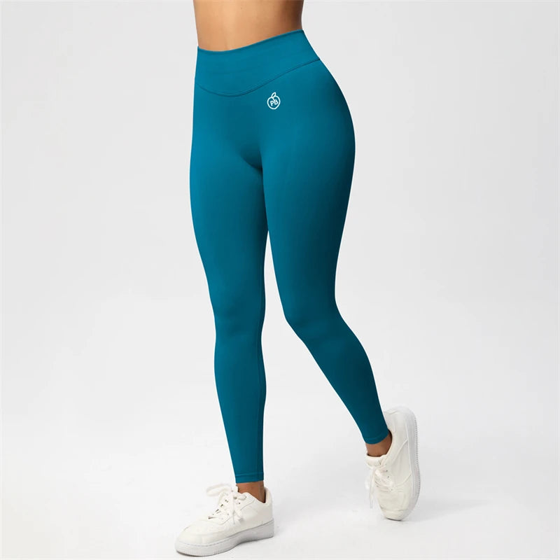 Fierce Ember Ultimate pale emerald-green high-rise seamless leggings with full-length sculpting fit and white hip logo, shown on a white studio background.