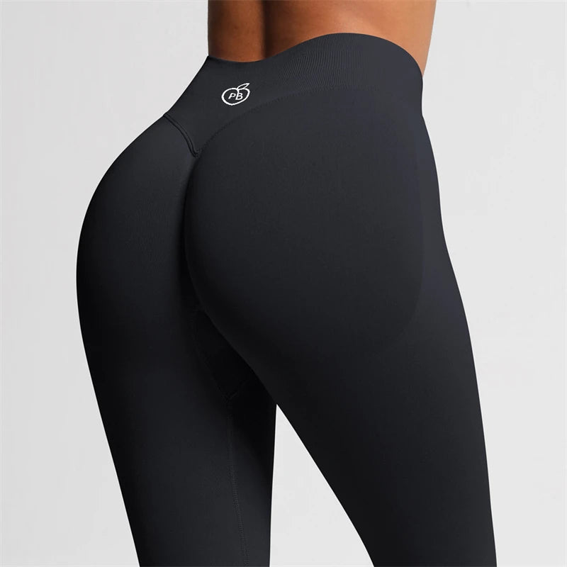 Close-up rear three-quarter view of white Fierce Ember Ultimate Leggings midnight black showing the sculpting waistband and contoured fit.