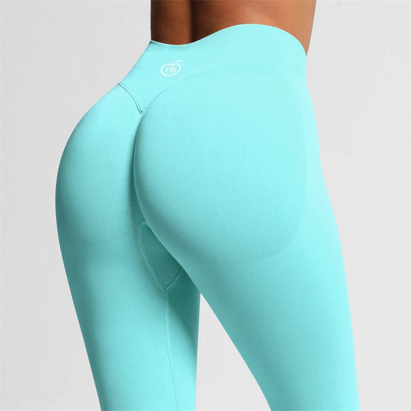 Fierce Ember Ultimate aqua green leggings close-up showing the sculpted back contour seam, high-rise waistband and white rear logo.