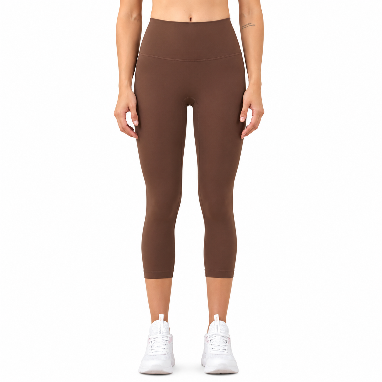 Front view of a model wearing Freedom Flow™ Studio Capri Leggings in cocoa earth. High-waisted women's yoga leggings with a sculpting, supportive fit by Mind Body & Soles.