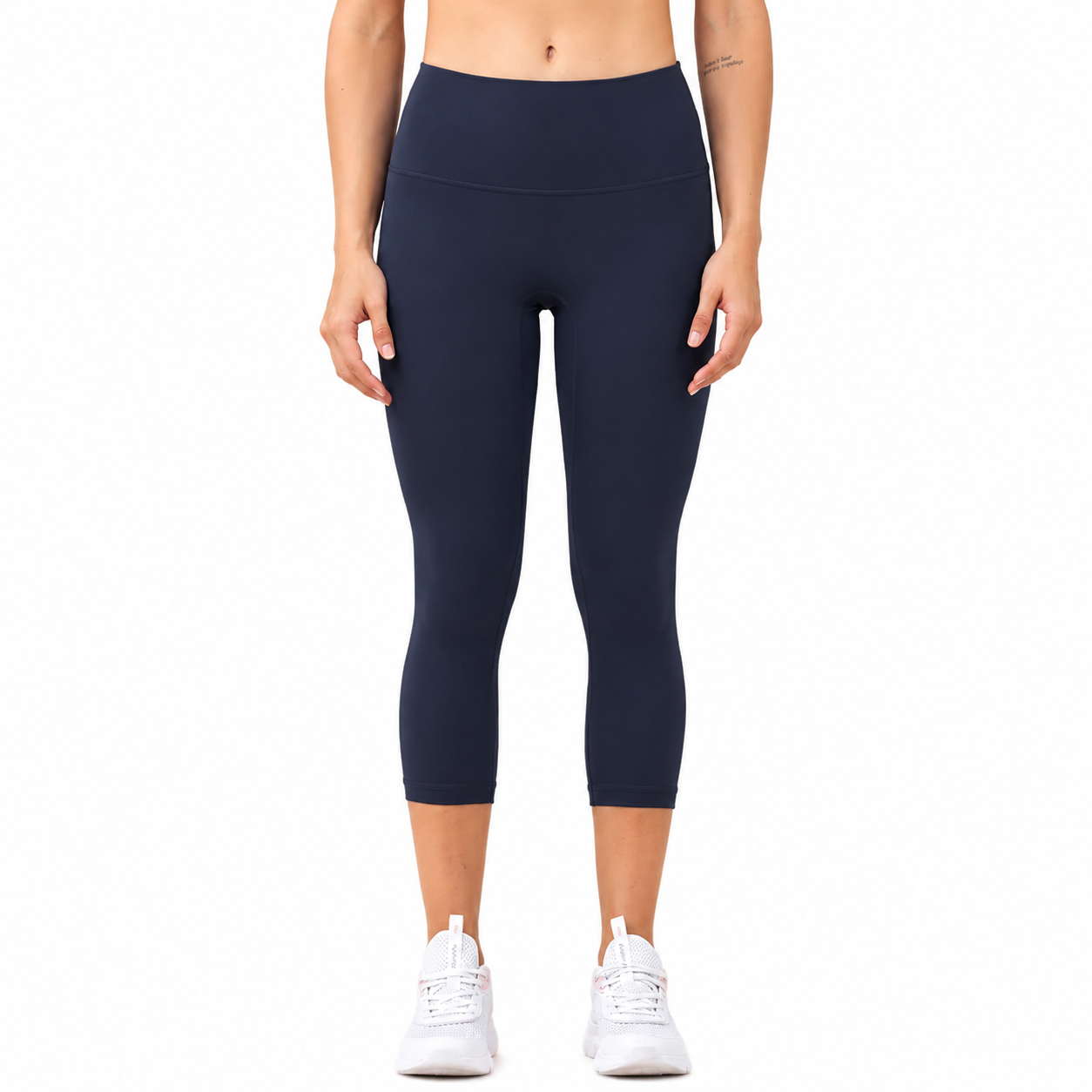 Front view of a model wearing Freedom Flow™ Studio Capri Leggings in deep ocean High-waisted women's yoga leggings with a sculpting, supportive fit by Mind Body & Soles.
