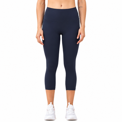Front view of a model wearing Freedom Flow™ Studio Capri Leggings in deep ocean High-waisted women's yoga leggings with a sculpting, supportive fit by Mind Body & Soles.