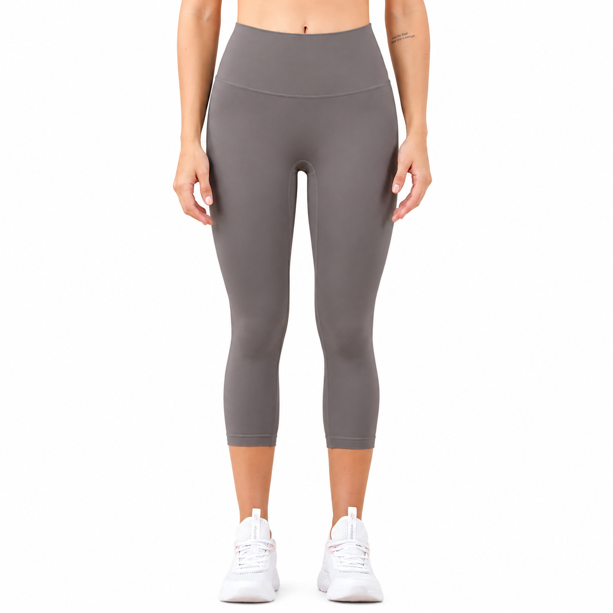 Front view of a model wearing Freedom Flow™ Studio Capri Leggings in mist grey. High-waisted women's yoga leggings with a sculpting, supportive fit by Mind Body & Soles.