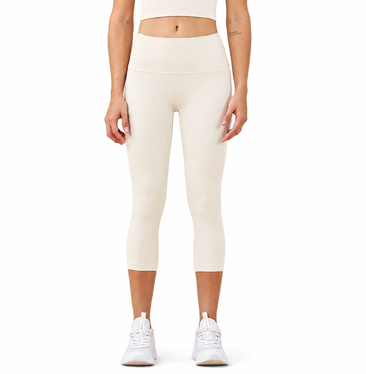 Front view of a model wearing Freedom Flow™ Studio Capri Leggings in pure ivory. High-waisted women's yoga leggings with a sculpting, supportive fit by Mind Body & Soles.