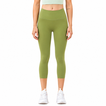 Front view of a model wearing Freedom Flow™ Studio Capri Leggings in tranquil sage. High-waisted women's yoga leggings with a sculpting, supportive fit by Mind Body & Soles.
