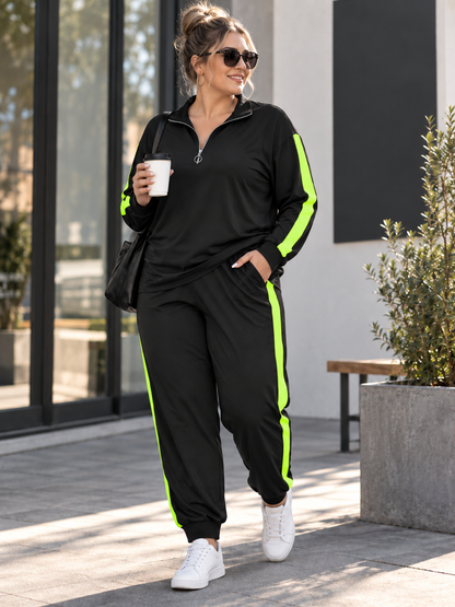 A woman wearing a black athletic tracksuit with bright neon green side stripes, walking outdoors on a paved area near a modern building. She is holding a white coffee cup and wearing white sneakers.