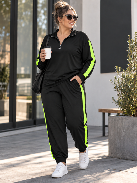 A woman wearing a black athletic tracksuit with bright neon green side stripes, walking outdoors on a paved area near a modern building. She is holding a white coffee cup and wearing white sneakers.