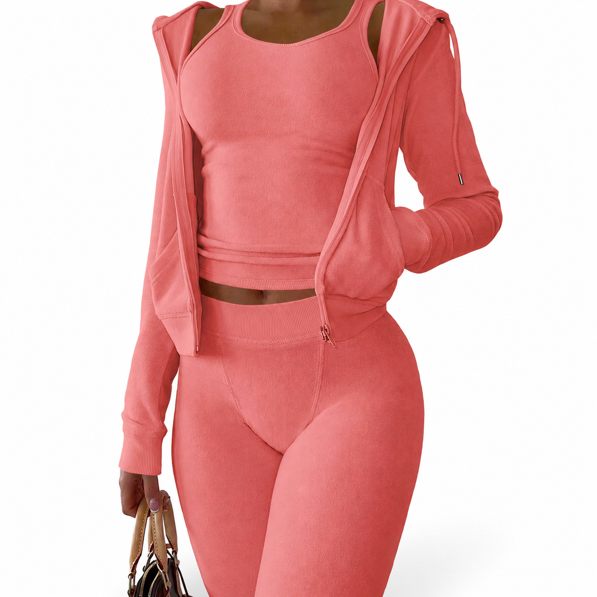 Model wearing Mind Body and Soles Activewear coral three-piece set with fitted vest, leggings, and hooded zip jacket.