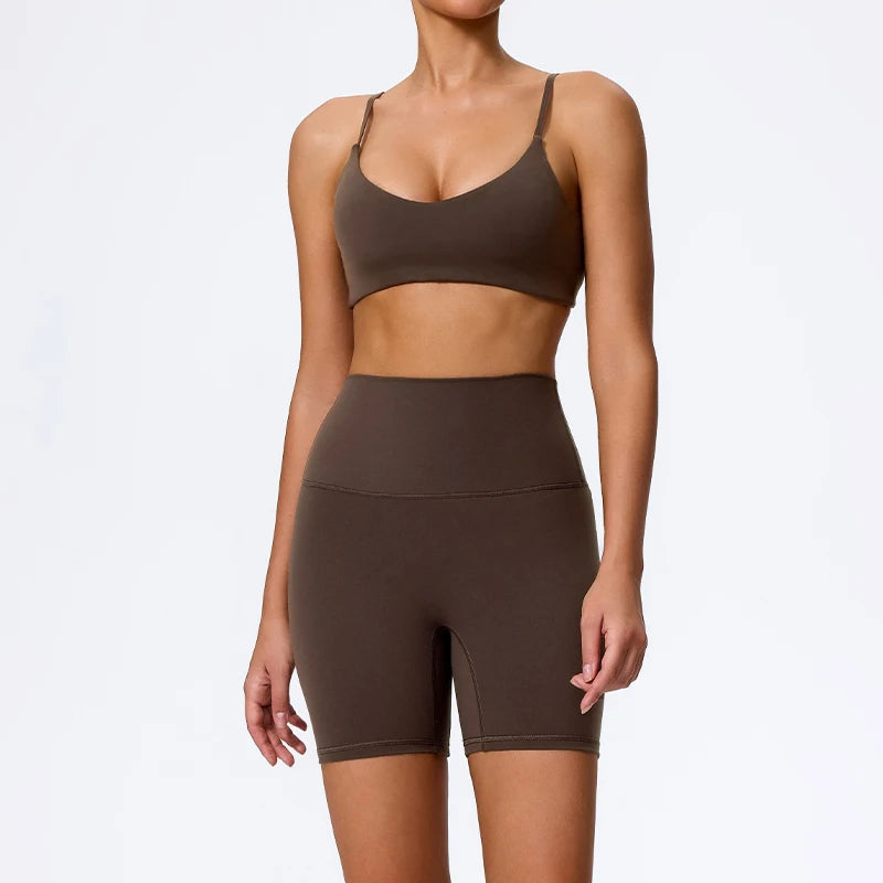 Mind Body and Soles Power Vibe Ignite Set in dark brown, premium women's two-piece activewear featuring a supportive sports bra and high-waisted bike shorts. Studio product image showcasing a sculpting fit, buttery-soft performance fabric, high-waisted support, four-way stretch, moisture-wicking comfort and squat-proof confidence for gym workouts, strength training, Pilates, yoga and everyday active living.