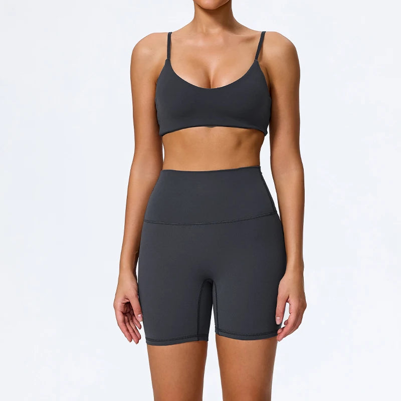 Mind Body and Soles Power Vibe Ignite Set in dark grey, premium women's two-piece activewear featuring a supportive sports bra and high-waisted bike shorts. Studio product image showcasing a sculpting fit, buttery-soft performance fabric, high-waisted support, four-way stretch, moisture-wicking comfort and squat-proof confidence for gym workouts, strength training, Pilates, yoga and everyday active living.